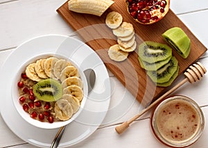 Homemade healthy breakfast: oatmeal with fresh fruits on bowl.