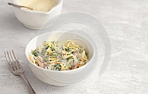Homemade healthy coleslaw salad with kale in white bowl on gray textured background