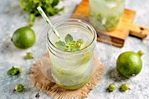 Homemade healthy non-alcoholic cocktail Mojito from green gooseberry, lime and mint.