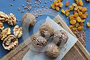 Homemade healthy raw vegan sweet balls with nuts,raisins, dates, cocoa and flax seeds. Healthy vegan food concept