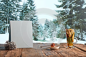 Homemade herbal or fruit tea. Glass pot, cup and sweets on wooden table over natural landscape background. Beauty, art