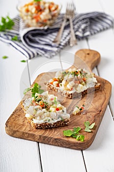 Homemade herring salad with fresh onions apple and herbs