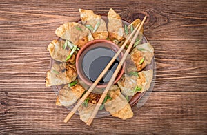 Homemade Ñhicken potstickers with soy sauce.