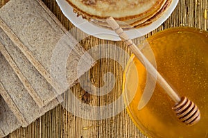 Homemade honey bread pancakes on a windward wooden background