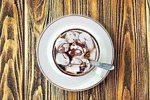 Homemade Hot Chocolate or Cocoa in White Mug with Marshmallows on wooden background. Top view.