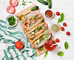 Homemade hot-dogs with fresh vegetables, spices, ketchup and mustard