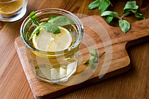 Homemade ice tea with lemon and mint leaves.