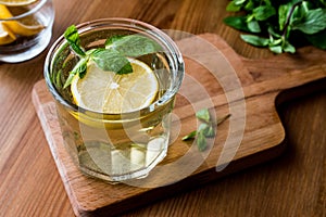 Homemade ice tea with lemon and mint leaves.