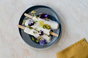 Homemade Indian Rajasthani Kulfi Ice Cream with Stick / Kesariya with Pistachio and Edible Flowers