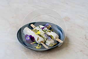 Homemade Indian Rajasthani Kulfi Ice Cream with Stick / Kesariya with Pistachio and Edible Flowers