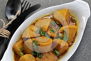 Homemade Indian Taro root  curry or Yam curry on a wooden moody background