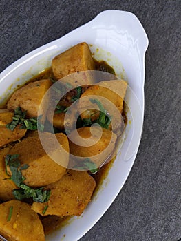 Homemade Indian Taro root  curry or Yam curry on a wooden moody background