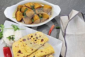 Homemade Indian vegetarian food of Yam or Taroo root curry with gluten free Besan Roti or Chickpea flour Roti on a wooden