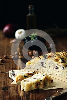 Homemade Italian Focaccia with mozzarella, hazelnut, red onion, black olive, garlic , rosemary and thyme