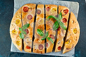 Homemade Italian Focaccia top view. Focaccia with tomatoes and garlic. Food background