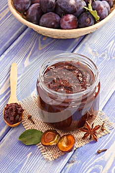 Homemade jam in jar, spices and ripe fruits in wicker basket, healthy sweet dessert