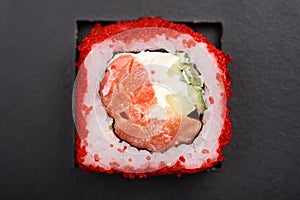 Homemade japanese roll with salmon, cucumber, cream cheese and r