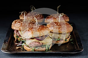 Homemade juicy burgers with beef, cheese and caramelized onions.