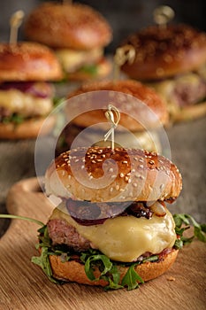 Homemade juicy burgers with beef, cheese and caramelized onions.