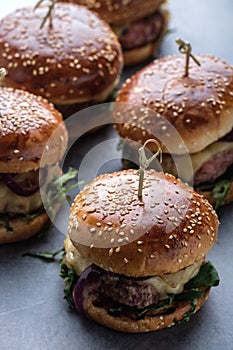 Homemade juicy burgers with beef, cheese and caramelized onions.