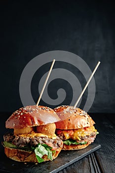 Homemade juicy burgers on wooden board