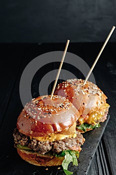 Homemade juicy burgers on wooden board