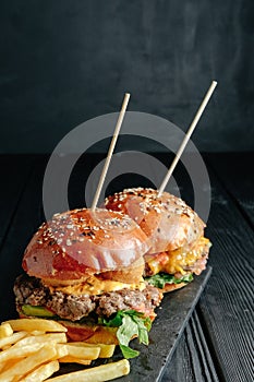 Homemade juicy burgers on wooden board