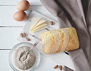 Homemade keto bread on white wooden table. top view of fresh baked low carb bread, LCHF diet concept. flourless baking. gluten