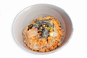 Homemade Kimchi fried rice with seaweed and white sesame on white background. kimchi bokkeumbap. photo