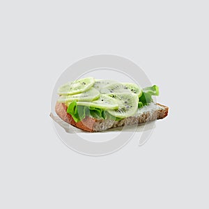 Homemade Kiwi fruit and cheese open sandwich for healthy breakfast isolated on a white background.