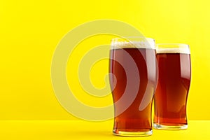 Homemade kvass in glasses on yellow background. Space for text