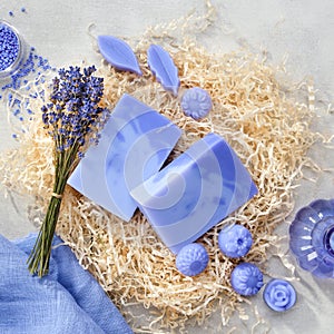 Homemade lavender soap bars and candy shaped soap, lavender extract bottle and dry lavender flowers.