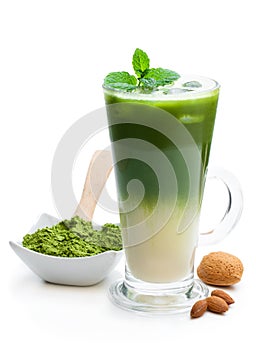 Homemade layered iced matcha latte tea with almond milk isolated on white