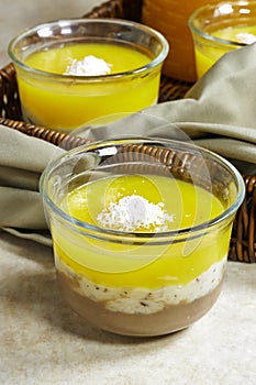 Homemade layered vegan dessert of baked coconut cream and chocolate in basket with milk bottle