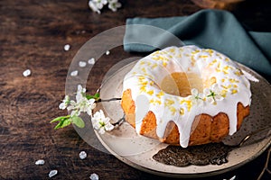 Homemade lemon bundt cake decorated with white glaze and zest