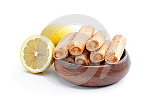 Homemade lemon jam filled sticks in wooden bowl isolated on white