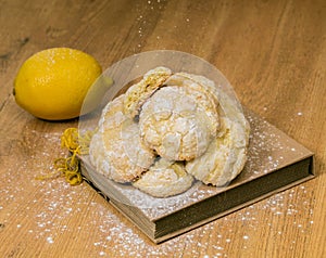 Homemade Lemon Sugar cookies with fresh lemon and peel closeup on the wooden background