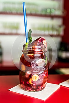 Homemade lemonade ice tea colorful icetea drink with fresh sweet fruits mint leaves in glass on the rocks with straw