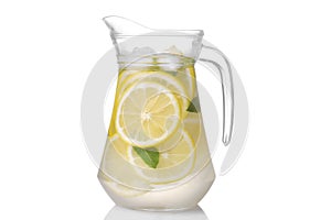 Homemade lemonade with mint and ice with a glass jug . isolated photo