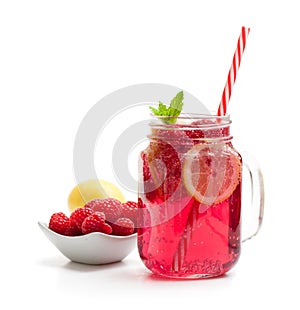 Homemade lemonade with raspberry and lemon isolated on white
