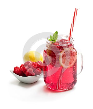 Homemade lemonade with raspberry and lemon isolated on white
