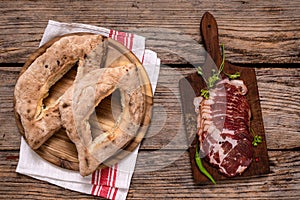 Homemade lepinja bread and appetizer on wooden background