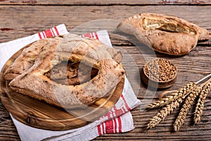 Homemade lepinja bread on wooden background photo