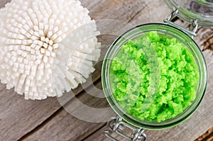 Homemade lime fruit scrub bath salt, foot soak, facial or hair mask in a glass jar and bath sponge. Natural beauty treatment,