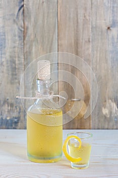 Homemade limonchello on the wooden table