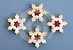 Homemade linzer cookies in a shape of snowflakes filled with strawberry jam