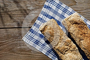 Homemade loaf of bread on kitchen cloth