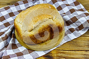 Homemade loaf of bread on wooden table freshly baked in an electric bread maker. Homemade baking