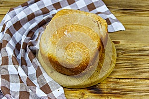 Homemade loaf of bread on wooden table freshly baked in an electric bread maker. Homemade baking
