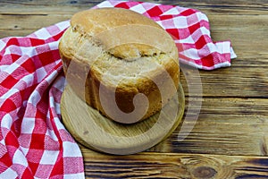 Homemade loaf of bread on wooden table freshly baked in an electric bread maker. Homemade baking